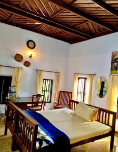 a bedroom with a large bed in a room at Cherys Bunglow Homestay- Rooms in Thiruvalla