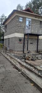 a house on the side of a street at Tommy's Lounge Apartments in Nairobi +2 photos