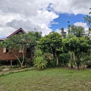 a house with trees and a grass yard at nam jai pai in Ban Wiang Nua