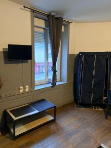 a living room with a table and a window at Gengoult 2 in Toul