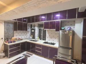 a kitchen with purple cabinets and a stainless steel refrigerator at 2 bhk flat available in tst in Hong Kong