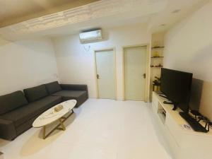 a living room with a couch and a tv at 2 bhk flat available in tst in Hong Kong