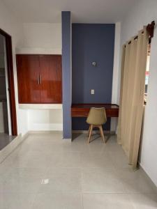 a kitchen with a desk and a chair in a room at Posada El Pejelagarto in Bacalar