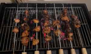 a bunch of food cooking on a grill at Spring Valley Homestay Rishop in Rishop