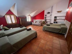 a large room with two beds and a couch at Casa rural collao de lobo in Serradilla
