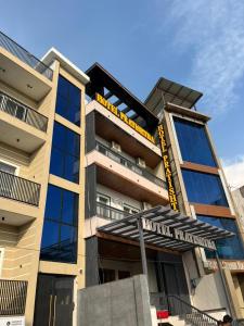 a building with a sign in front of it at Hotel Pratishtha in Rishīkesh