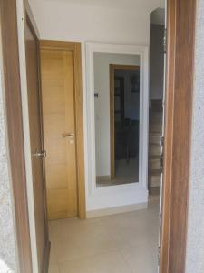 a door with a mirror in a room at Andreamar in Cambados