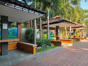 a pavilion with benches and tables in a park at The Ginger Ville Private Resort in Lian
