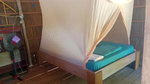 a bed in a room with a tent at War Nyampun Homestay in Waisai