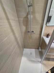 a shower with a shower head in a bathroom at L'Escapade Chablisienne in Chablis +26 photos