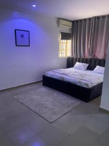 a bedroom with a bed and a window at Haven Residence in Rubuchi