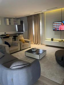 a living room with a couch and a tv at Haven Residence in Rubuchi