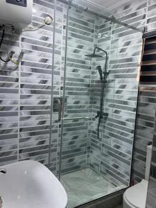 a bathroom with a glass shower with a toilet at Haven Residence in Rubuchi