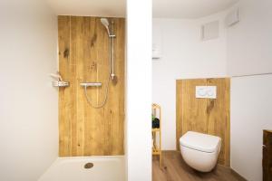 a bathroom with a shower and a toilet and a tub at Holzhaus im Schwedenstil in Scharnhorst +28 photos