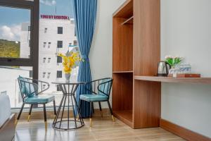 a dining room with a table and chairs and a window at Vinh Hy Horizon in Vĩnh Hy
