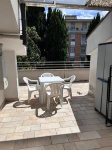 a white table and chairs on a patio at Hotel Alex in Florence