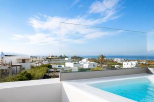 a view from the balcony of a villa with a swimming pool at Stay Lux Suites in Karterados