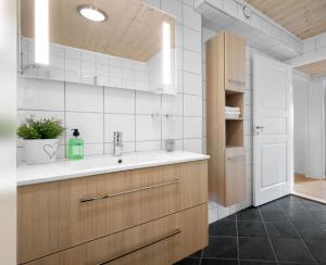 a bathroom with a sink and a mirror at Voss Resort self-service apartments in Skulestadmo +281 photos