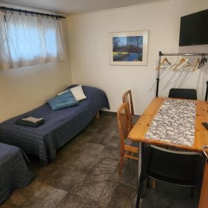 a room with a table and a bed and a dining room at Afrodite Rooms in Naantali