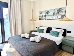 a bedroom with two beds with towels on the bed at Azur Mare Luxury Villas in Neoi Epivates