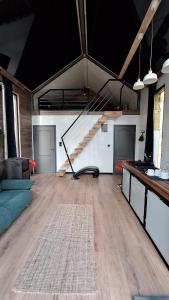 a living room with a staircase in the middle of a room at Domki Wieck in Czarna Woda