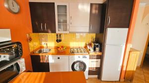 a small kitchen with a white refrigerator and a dishwasher at Apartment Segura 2BD in Rojales +30 photos