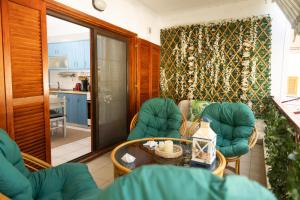 a living room with a table and chairs and a kitchen at Touzla Blue Heaven in Orfánion