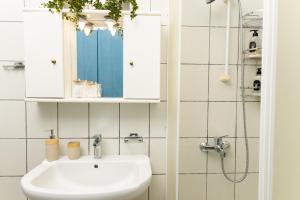 a white bathroom with a sink and a mirror at Touzla Blue Heaven in Orfánion +29 photos