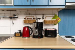 a kitchen counter with appliances on a counter top at Touzla Blue Heaven in Orfánion