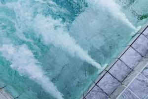 a pool of water with a wave in it at Villa Escape Aonang Krabi in Krabi