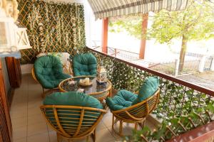 a balcony with chairs and a table on a patio at Touzla Blue Heaven in Orfánion