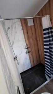 a bathroom with a shower with a marble counter top at Domki Wieck in Czarna Woda +25 photos