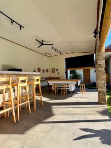 a patio with a ping pong table and chairs at Di rumah Vima homestay in Pemuteran