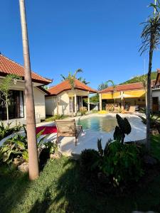 a house with a swimming pool in the yard at Di rumah Vima homestay in Pemuteran