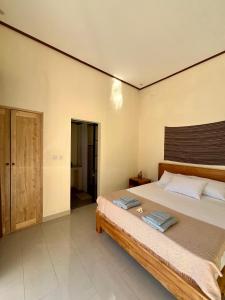 a bedroom with a large bed in a room at Di rumah Vima homestay in Pemuteran +21 photos