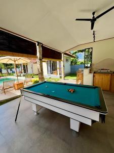 a pool table in the middle of a living room at Di rumah Vima homestay in Pemuteran