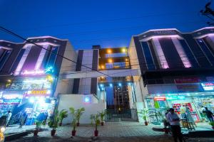 a group of buildings with neon lights on them at Surendra Landmark By Spree Hotels Bhopal in Bhopal
