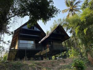 a house on top of a hill with trees at Casa Kabani Resort in Chegāt +13 photos