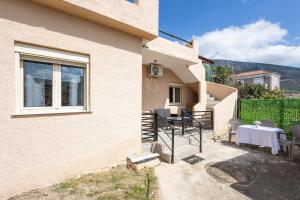 a house with a table and chairs outside of it at K&J House in Didyma
