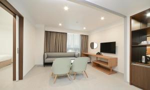a hotel room with a table and two chairs at Staz Hotel Heritage in Jeju