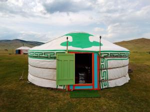 a large dome tent with a green door in a field at Mongolian traditional Ger accomodation in Narst +16 photos