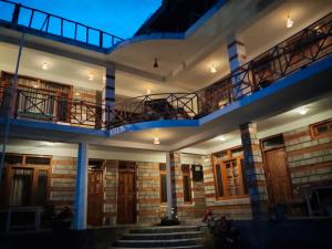 a building with two balconies on top of it at Monal House in Manāli +18 photos