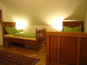 a bedroom with a bed with green pillows at Apartmány na hájovně in Jeseník