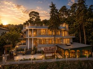a large house with a lot of windows at Hotel Valna Estate Himalyan View Kausani By HRG in Kausani