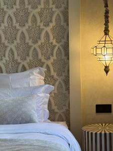 a bedroom with a bed and a wall with a pattern at Maison Zamane in Marrakesh