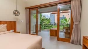 a bedroom with a bed and a balcony at Alingga Cottage in Ubud +45 photos