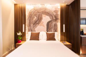a bedroom with a large bed with a wall mural at Residence Lido di Dante in Lido di Jesolo