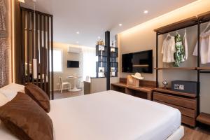 a bedroom with a large bed and a television at Residence Lido di Dante in Lido di Jesolo +83 photos