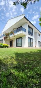 a large white house with a large grass yard at Villa Kalinda Your Private Sheltered Luxury Villa with Pool Minutes Away from Dalaman Airport in Dalaman