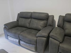 a brown leather couch sitting next to a white wall at Andreamar II in Cambados +66 photos